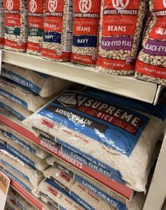 Supreme Rice on the store shelf with beans on the shelf above