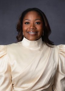 picture of woman in an off-white dress with a high neck and puffy sleeves