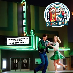 young 50's era couple dancing in front of the Rice theater