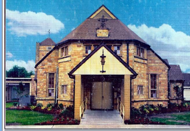 stone church building with cloudy, blue sky