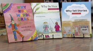Three colorful children's books propped up on a table