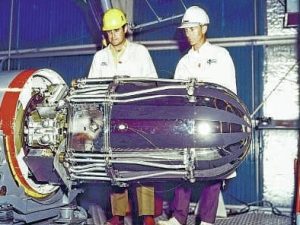 Two NASA engineers standing near spacecraft