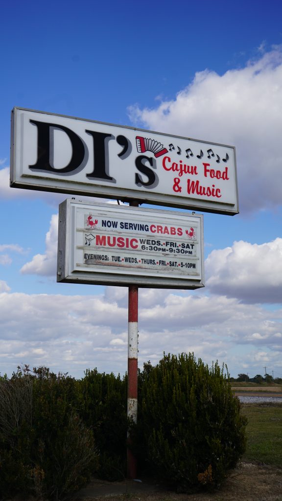 Raised sign against sky background, DI's Cajun Restaurant