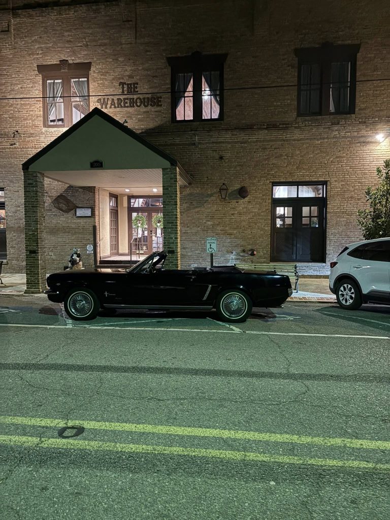 The Warehouse in Rayne building front with classic car