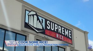 Freeze frame of News Forecast featuring the front sign of Supreme Rice