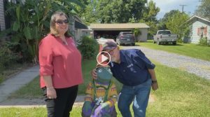 Chere Ledoux and Al Hebert with frog statue