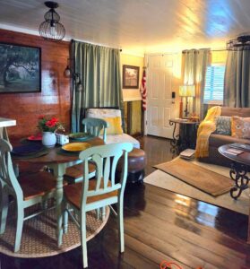 Living and dining room combo with wood grain accent wall and flooring