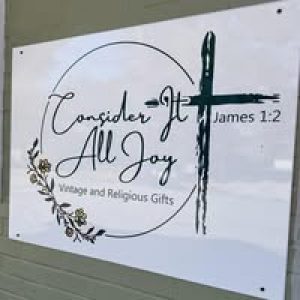 White sign with black logo for Consider it all Joy