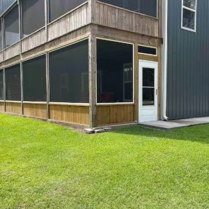 exterior image of blue building with screened in porch