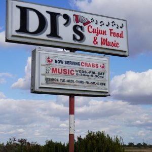 Raised sign against sky background, DI's Cajun Restaurant