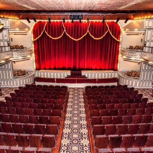 Opera House interior with large red curtain across the stage