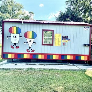 small portable building with snowcones painted on the side