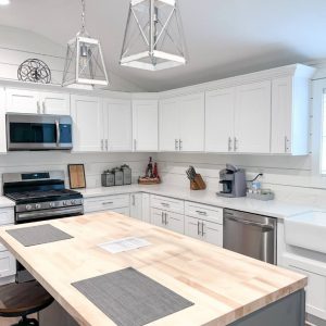kitchen with white cabinets and large butcher-block island