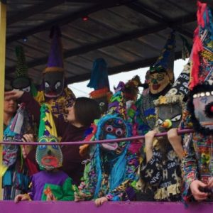 Mardi Gras riders in traditional dress on a parade float