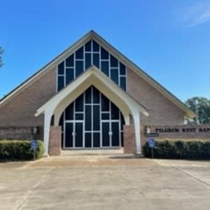brick church building with large windows on the front