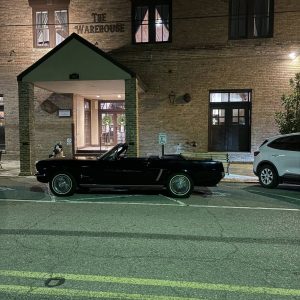 The Warehouse in Rayne building front with classic car